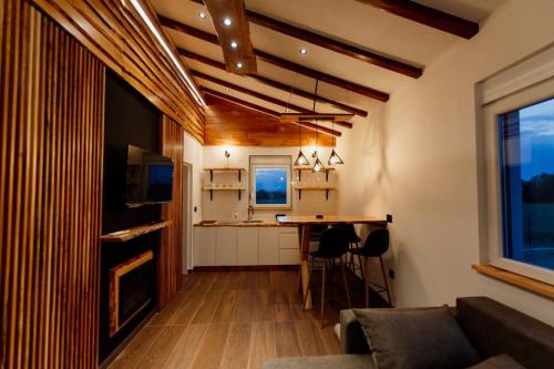 a living room with a couch and a table at Sunny Apartments in Malo Laole