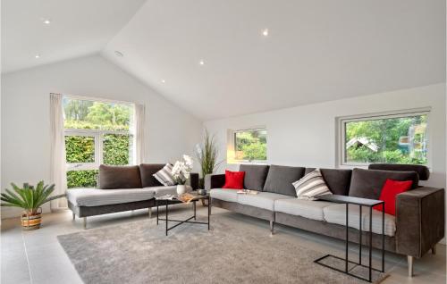 a living room with two couches and red pillows at Pet Friendly Home In Dronningmølle in Dronningmølle