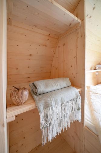 a wooden sauna with a bed and a blanket at Notte nella Botte in Vignale Monferrato