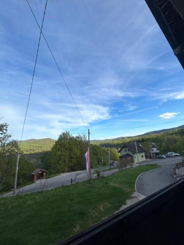 a view from a window of a road with a flag at Apartment Mila in Plitvička Jezera