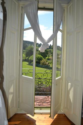 an open door to a balcony with a view at Posada Casa de Valle in Colindres