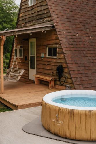 a large hot tub in front of a log cabin at Rustic Escape UTV, Tub, Trails & Fire Pit 25 acre in Roscoe