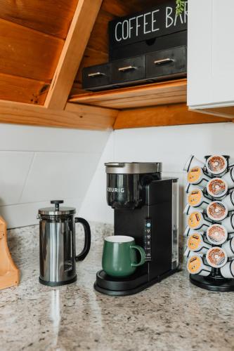 a kitchen counter with a coffee maker and a microwave at Rustic Escape UTV, Tub, Trails & Fire Pit 25 acre in Roscoe