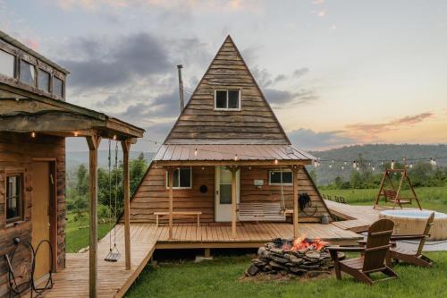 a small house with a roof on a wooden deck at Rustic Escape UTV, Tub, Trails & Fire Pit 25 acre in Roscoe