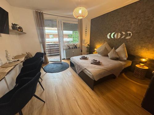 a bedroom with a bed and two chairs in it at BOHO Apartment Elegance in Bad Reichenhall