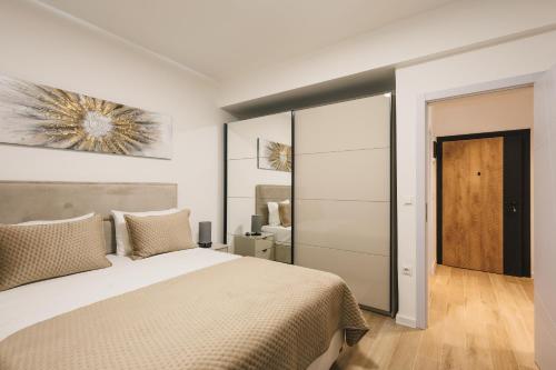 a bedroom with a bed and a sliding glass door at Dani Deluxe Apartments in Ulcinj