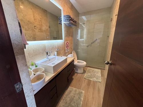 a bathroom with a sink and a toilet and a mirror at Apartment with Excellent Ocean View, Terra 194 in Cabo San Lucas