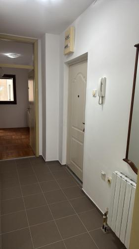 a hallway with a door and a tile floor at Peace in the heart of downtown in Pančevo
