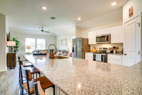 a kitchen with a large island in a kitchen with white cabinets at 12 Mi to Avery Island Spacious Family Home! in New Iberia