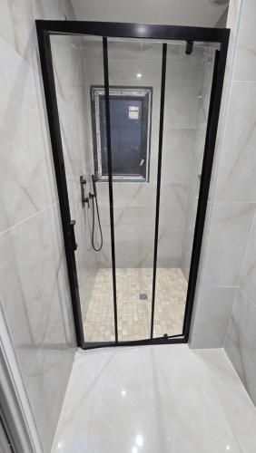 a shower with a glass door in a bathroom at Villa le H in Lavalette
