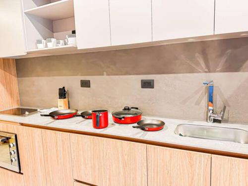 a kitchen with three pots and pans on a counter at Skyline Suites - Elegant Living with Coworking & Scenic Views in Bogotá