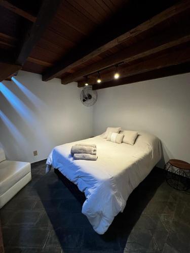 a bedroom with a bed with towels on it at Casa da Tia Iche in Espirito Santo Do Pinhal
