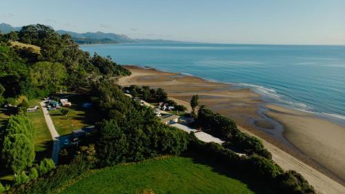 an aerial view of a beach and the ocean at Golden Bay Holiday Park in Onekaka