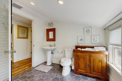 a bathroom with a toilet and a sink at Bay Cottage in Boothbay Harbor