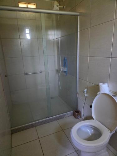 a bathroom with a shower and a toilet at Pousada Sítio do Engenho in Escada