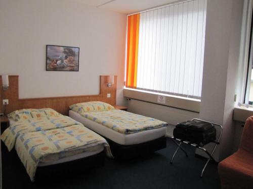 Postel nebo postele na pokoji v ubytování Budget Motel Self Check-In