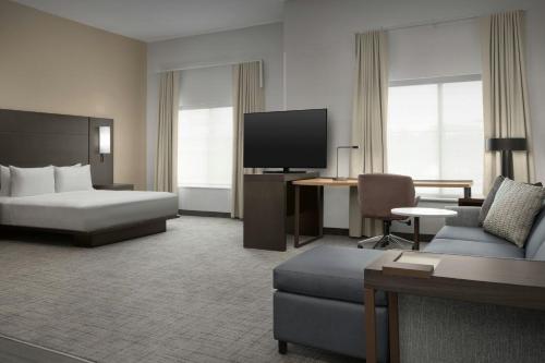 a hotel room with a bed and a tv at Residence Inn by Marriott San Antonio SeaWorld /Westover Hills in San Antonio