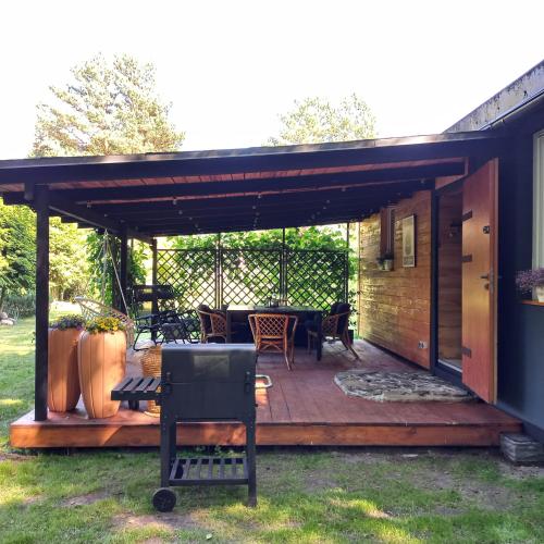a patio with a table and chairs on a deck at Jeziorskie Zacisze 