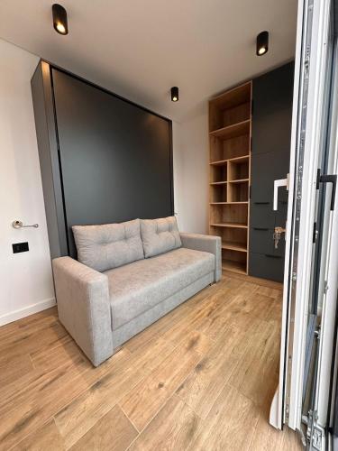a couch in a room with a large screen at Tinyhome Murtal -SlowCamping in Fohnsdorf