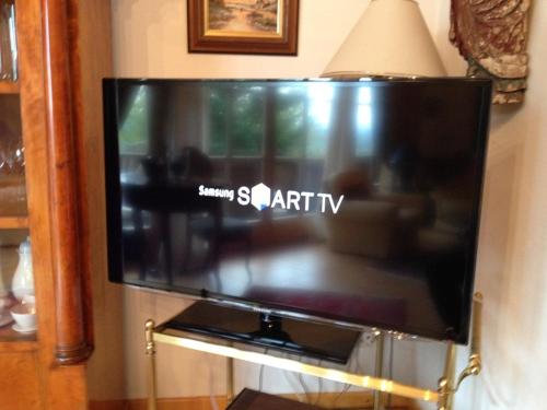 a flat screen tv hanging on a wall at Chalets in der Forststraße in Miltach