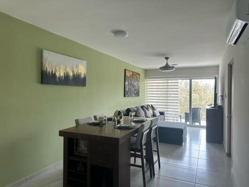 a kitchen and living room with a table and chairs at Modern Oceanfront Retreat 2BD 2BDR Wifi Pool in Veracruz