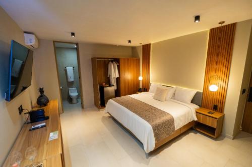 a hotel room with a bed and a bathroom at Casa Mía Hotel Boutique in Zamora de Hidalgo