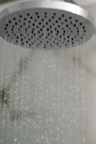 a shower filled with water with a shower at Alexandros mini suites in Santorini