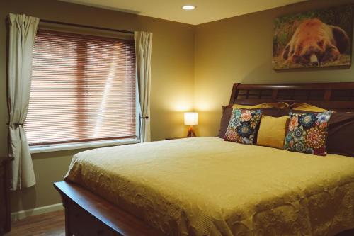 a bedroom with a large bed and a window at Lakeshore Lodging Apartment G in Homer