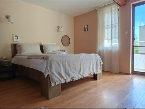 a bedroom with a bed and a large window at Bo's place in St. St. Constantine and Helena