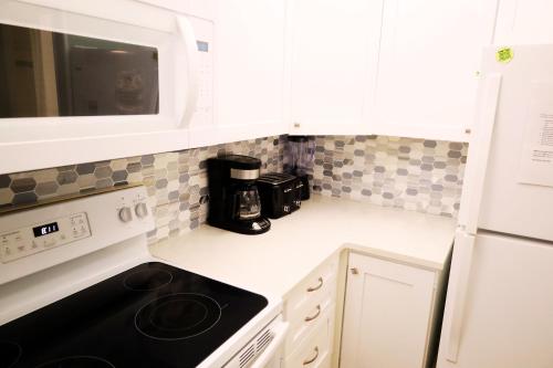a kitchen with a stove and a microwave at Mariner East in Panama City Beach