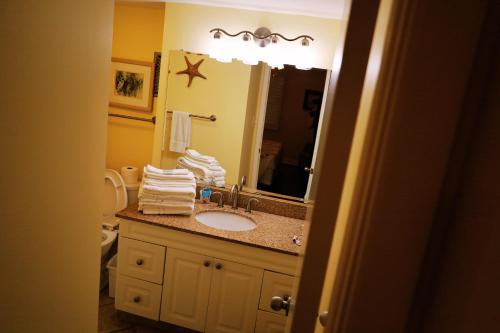 a bathroom with a sink and a mirror at Mariner East in Panama City Beach