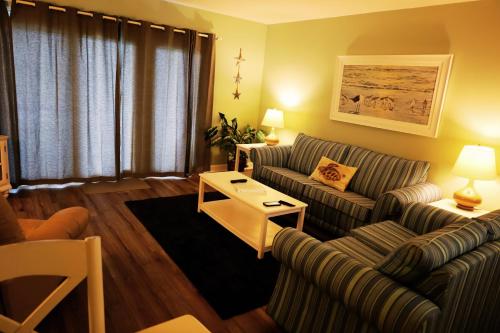 a living room with a couch and a table at Mariner East in Panama City Beach