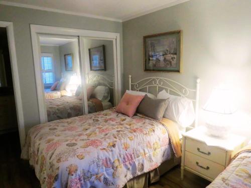 a bedroom with a bed and a mirror at Mariner East in Panama City Beach