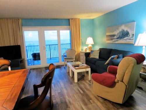 a living room with a couch and a table at Mariner East in Panama City Beach