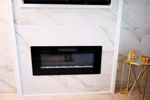 a living room with a fireplace in a white wall at Mariner East in Panama City Beach