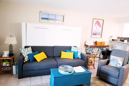a living room with a couch and two chairs at Mariner East in Panama City Beach