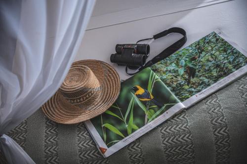 a hat and a camera sitting next to a box at Waka Hotel Rural in Honda