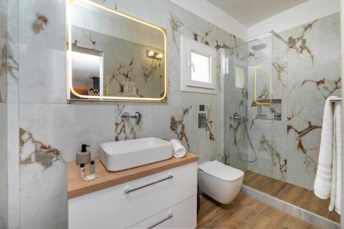 a bathroom with a sink and a shower at Alexandros mini suites in Santorini