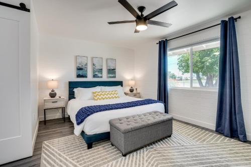 a bedroom with a large bed and a window at 5 Mi to State Farm Stadium Sun City Retreat in Sun City