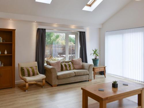 a living room with a couch and a table at Belmont in Longton