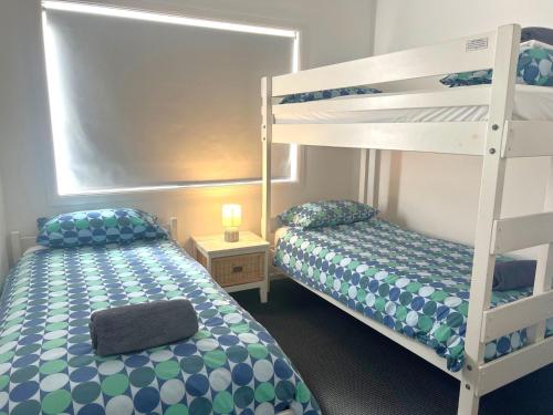 a bedroom with a bunk bed and a bunk bedouble at Avalon 3 in Yamba