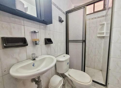 a bathroom with a toilet and a sink and a shower at Condo-Panoramic Elevator-10 Min Walk-Rodadero Beach in Santa Marta