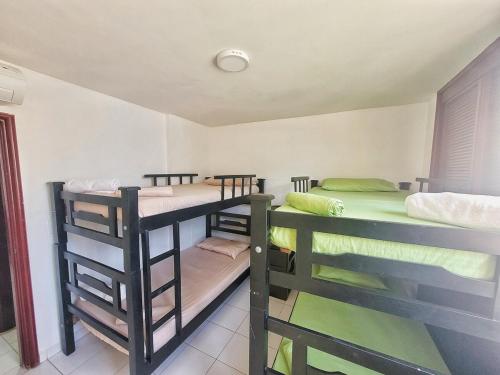 a room with three bunk beds in a room at Condo-Panoramic Elevator-10 Min Walk-Rodadero Beach in Santa Marta