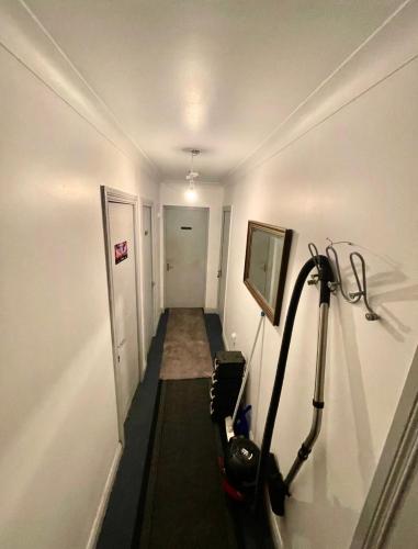 a hallway with a room with a treadmill at Double Room in a Cozy shared apartment, Custom House Harbour Apartments in Dublin