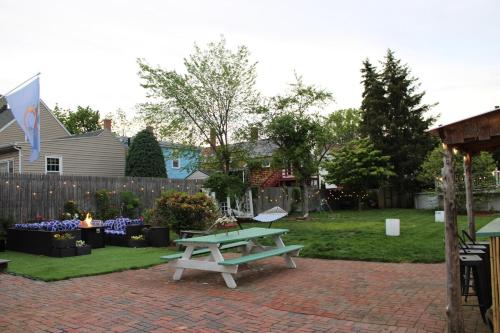 a picnic table on a brick patio in a yard at Witch City Retreat with Tiki Bar in Downtown Salem in Salem