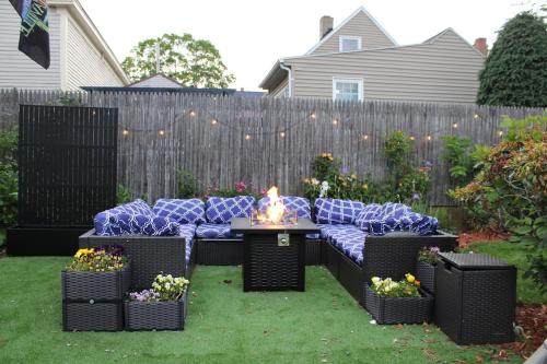 a backyard with a couch and a fire pit at Witch City Retreat with Tiki Bar in Downtown Salem in Salem