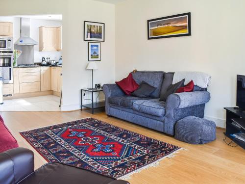 a living room with a couch and a rug at Lime Court - Cottages in Leatherhead