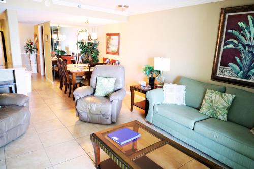 a living room with two couches and a table at Mariner East in Panama City Beach