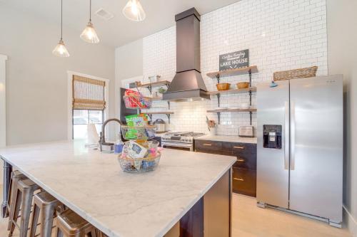 a kitchen with a large island with a refrigerator at Walk to Lake Home with Community Perks in Canadian! in Canadian