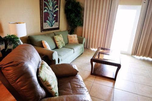 a living room with a couch and a table at Mariner East in Panama City Beach
